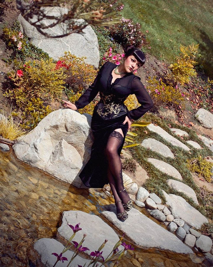 Girl standing by water