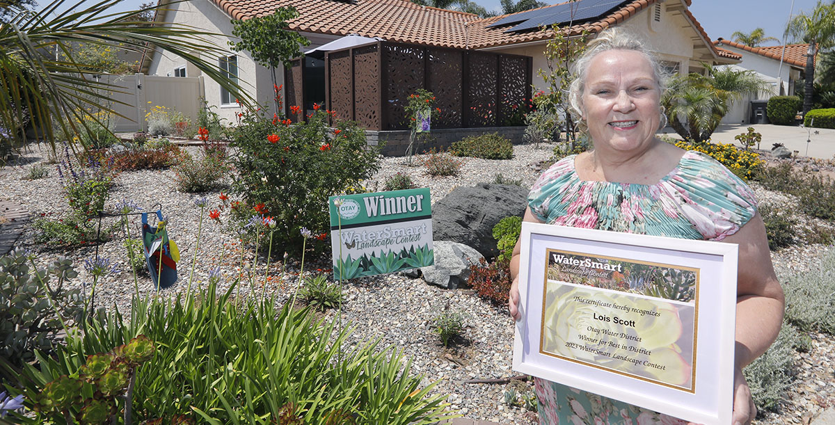 Landscape Contest winner standing in her yard